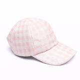 Pink checkered baseball cap on a white background