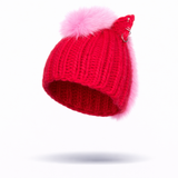 Side-facing image of red knitted beanie with a pink pom-pom and silver hoops on a white background