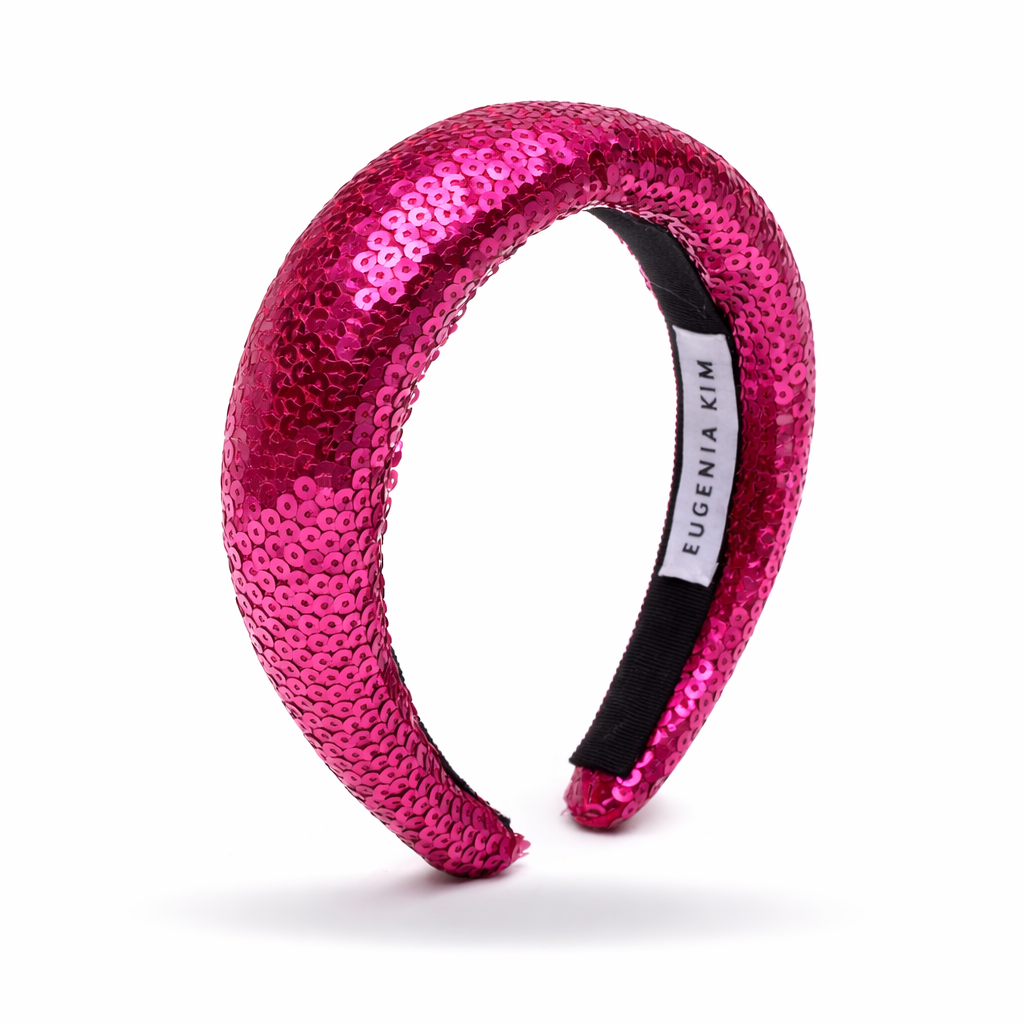 Fuchsia sequined headband with a brand label on a white background