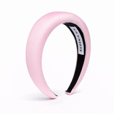 Pink headband with black interior on a white background