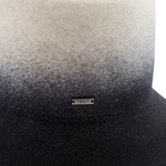 Gradient hat with black and gray color scheme and a brand label on a white background