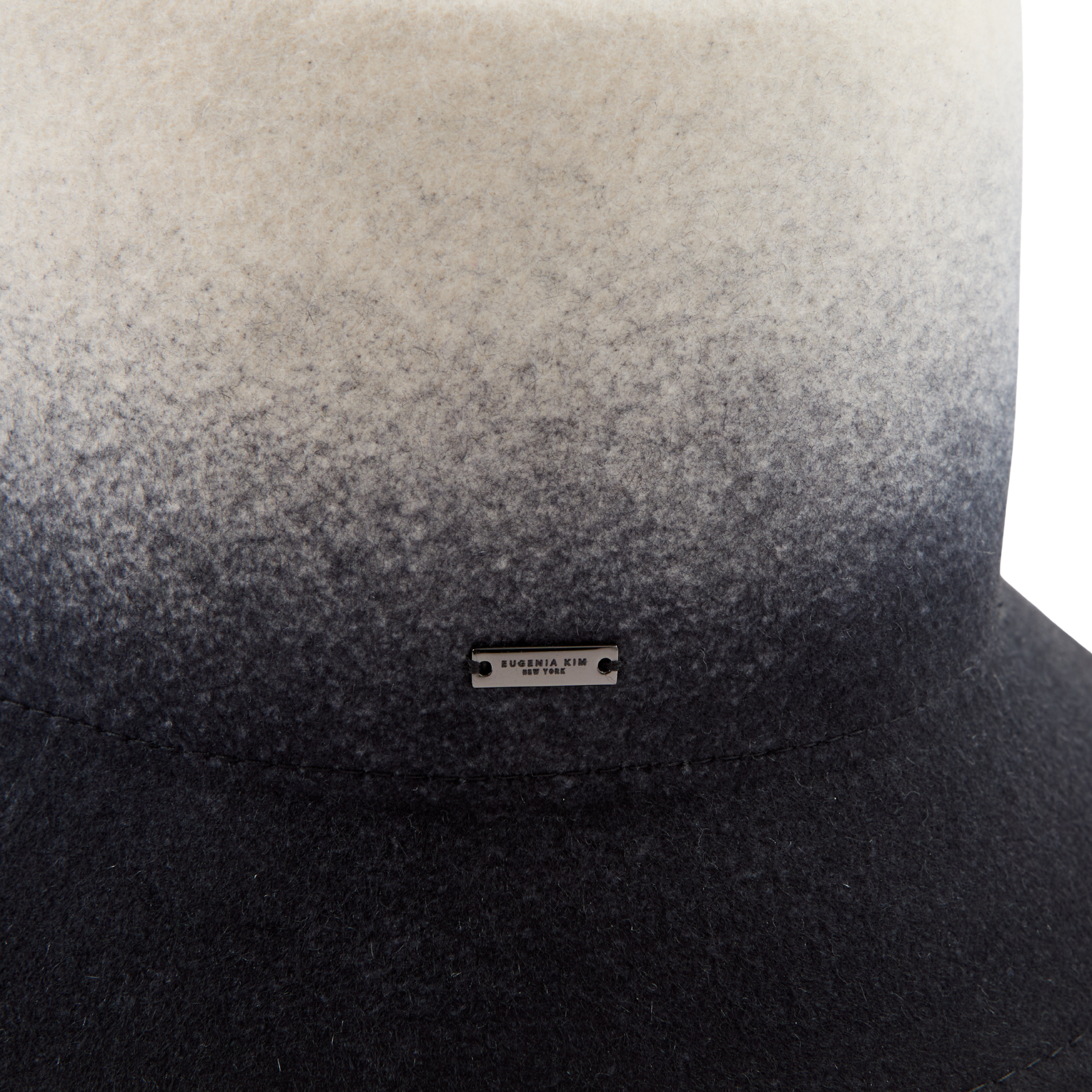 Gradient hat with black and gray color scheme and a brand label on a white background