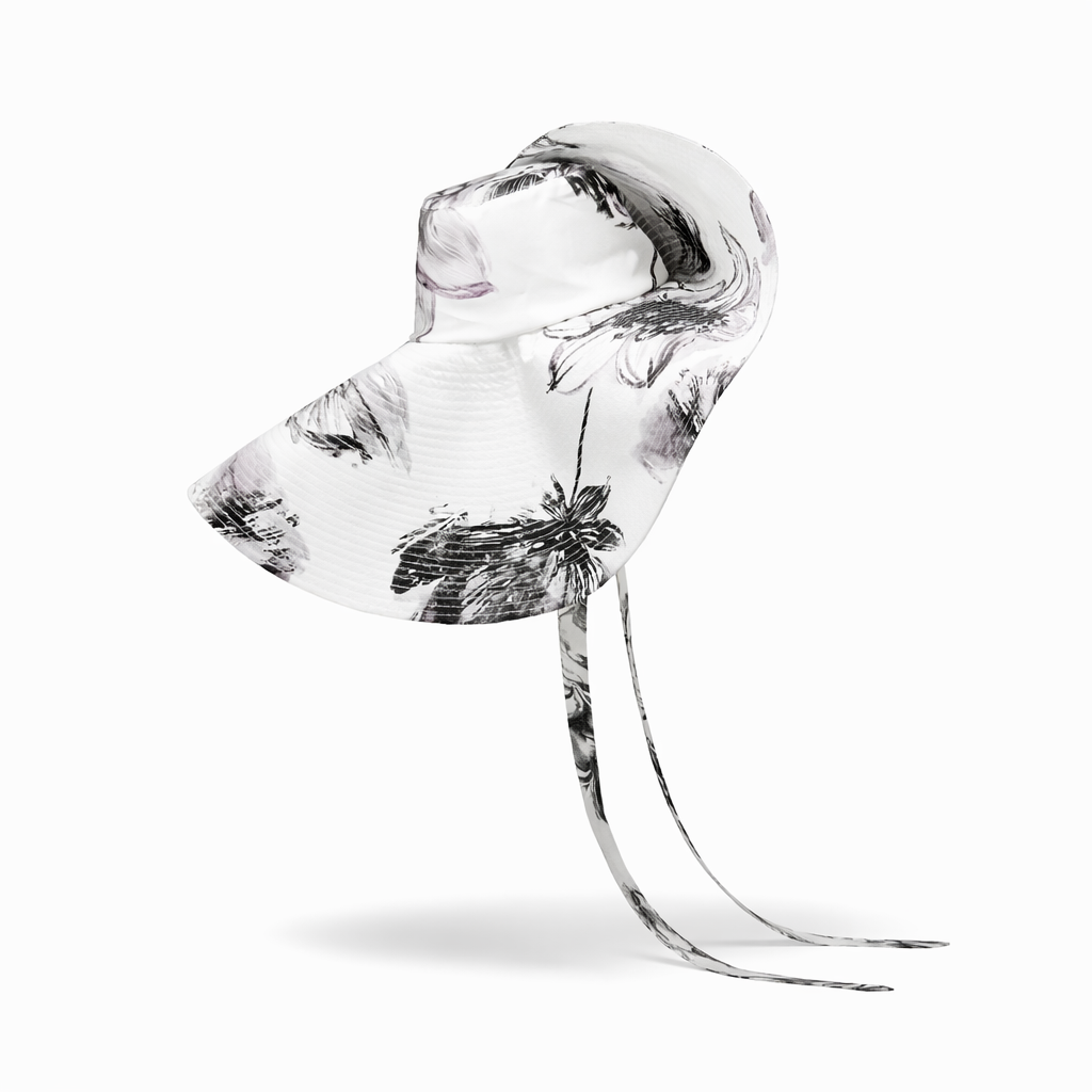 Clear glass sculpture with black floral patterns on a white background