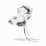 Clear glass sculpture with black floral patterns on a white background