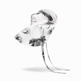 Clear glass sculpture with black floral patterns on a white background