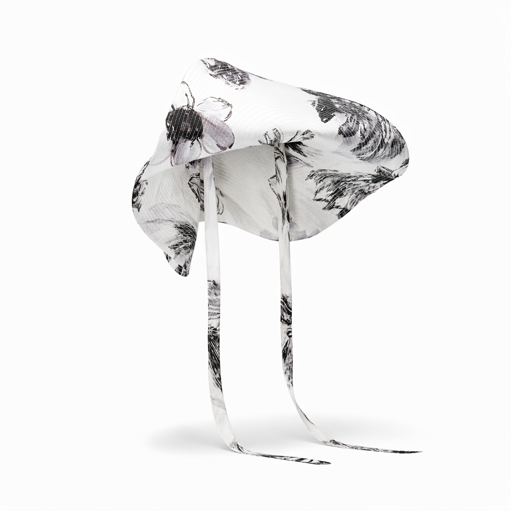 Clear glass sculpture with black and white abstract design on a white background