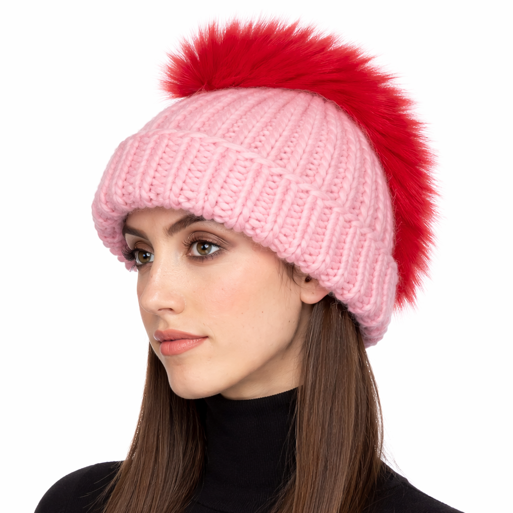 Woman wearing a pink knit beanie with a red pom-pom on a white background