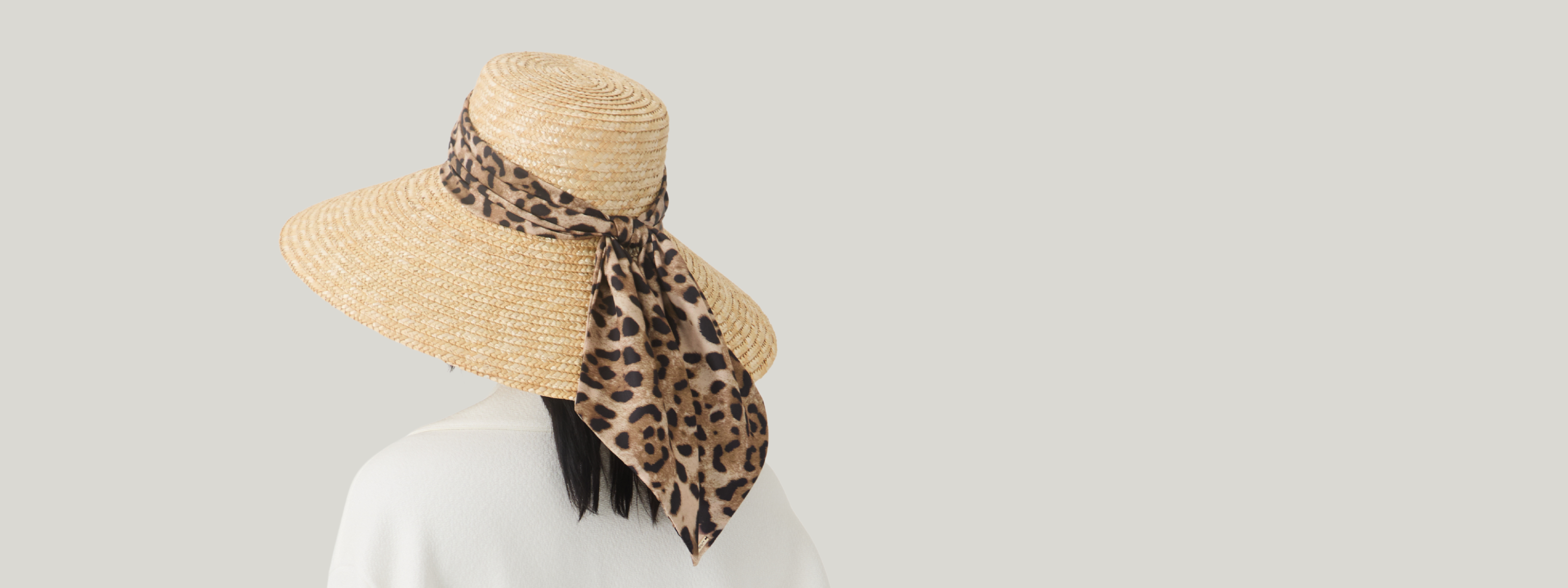 Model wearing the Mirabel leopard-print sunhat in the Cruise 2026 campaign hero image.