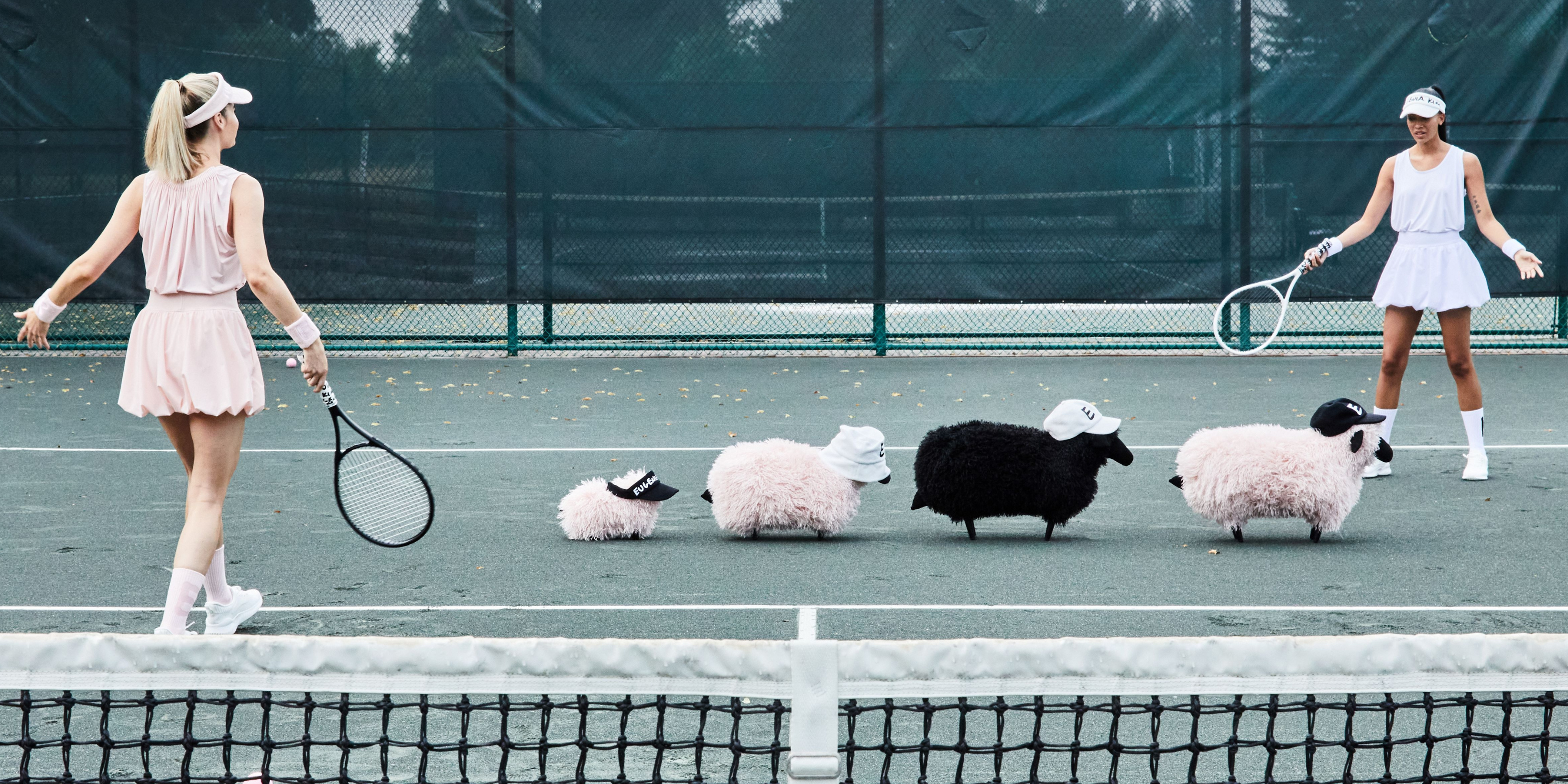 Models wearing Eugenia Kim EK LOVE tennis-inspired hats and headbands in white and neutral tones on a tennis court, featured in the 60% Off Black Friday Insider Collection.