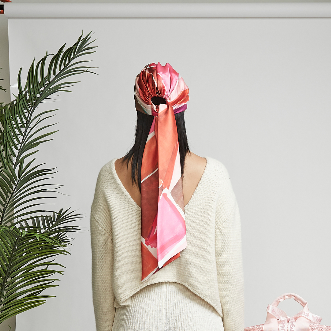 Eugenia Kim Gigi Head Scarf in pink and red satin with long tails, luxury women’s silk headscarf for elegant styling.