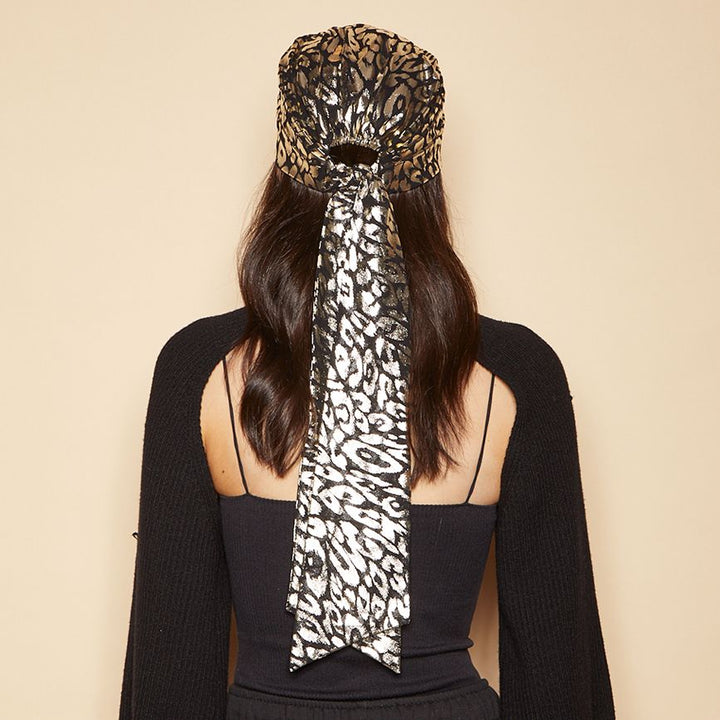 Eugenia Kim Gigi headscarf in gold/black leopard back view on model