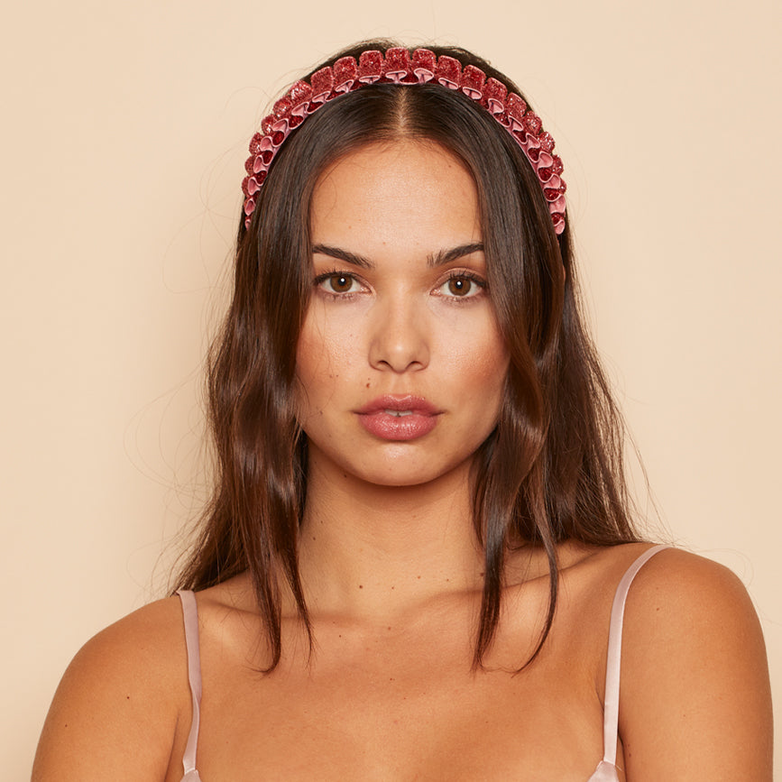 Rafaela pleated headband in metallic rose on model.