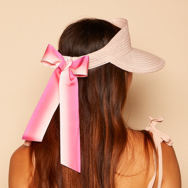 Back view of Ricky visor in pink with pink ombre tails on model.